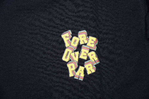 A close-up of a black t-shirt featuring a colorful graphic that reads 'FORE OVER PAR' in a playful, layered 3D block font with yellow, pink, and blue accents.
