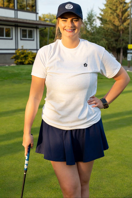 5'10" Female  standing on a golf course wearing a Large Clubhouse Tee and Black 19th Hole Rope Hat by Fore Over Par 