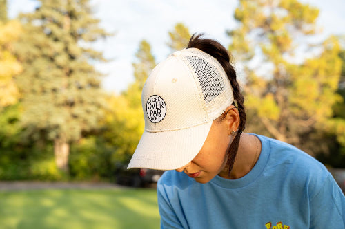 Female wearing a cream Pony Tail Club hat by Fore Over Par on Golf course