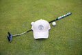 Cream Pony Tail Club Hat y Fore Over Par on a golf green with putter and golf balls behind it