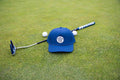 Dark Blue 19th Hole Rope Hat shown on green with a putter and two golf balls behind it 