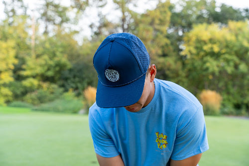 Male wearing 19th Hole Rope Hat by Fore Over Par on golf course