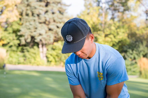 Male wearing a 19th Hole Rope Hat by Fore Over Par on a golf course
