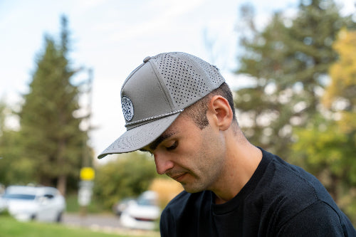 Man wearing a 19th Hole Rope hat by Fore Over Par on a golf course