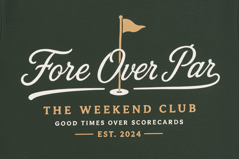 A white logo shown on a green shirt that reads 'Fore Over Par' with "The Weekend Club, Good Times Over Scorecards' underneath