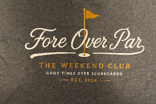 Dark heather gray t-shirt featuring a printed graphic on the chest with the words 'Fore Over Par' in white script, a gold golf flag illustration, and 'THE WEEKEND CLUB' and 'EST. 2024' in gold.
