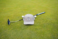 Grey 19th Hole Rope hat by Fore Over Par shown on golf green with putter and two golf balls behind it. 