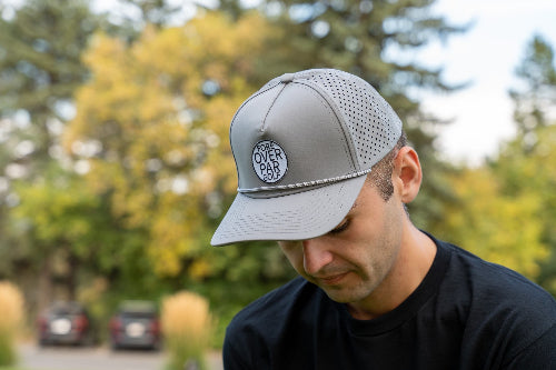 Man wearing a 19th Hole Rope hat by Fore Over Par on a golf course
