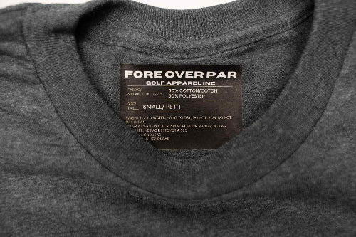 Close-up of the inside collar of a  grey t-shirt, showing a brand label that reads 'FORE OVER PAR GOLF APPAREL, INC.'.