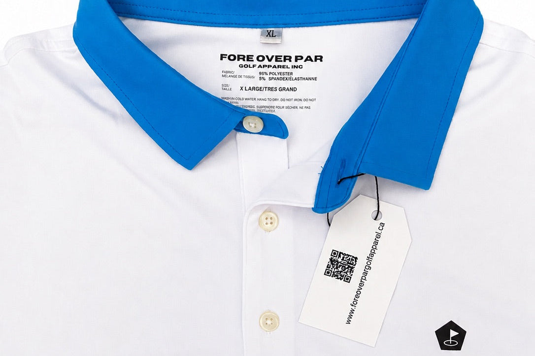 White polo shirt with a bright blue collar, featuring a three-button placket, a hangtag, and a small black Fore Over Par logo on the left chest.